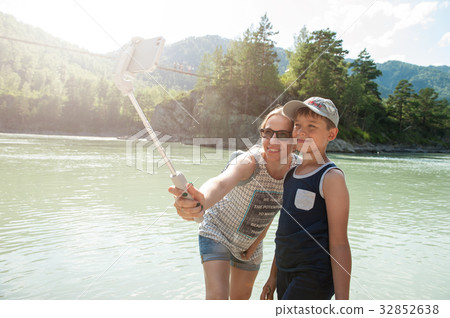 selfie on mobile phone with stick 32852638