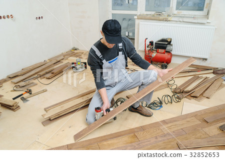Installing a wooden floor. 32852653