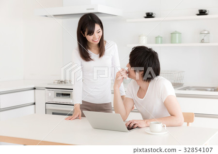 A couple relaxing in the kitchen A couple relaxing in the kitchen 32854107