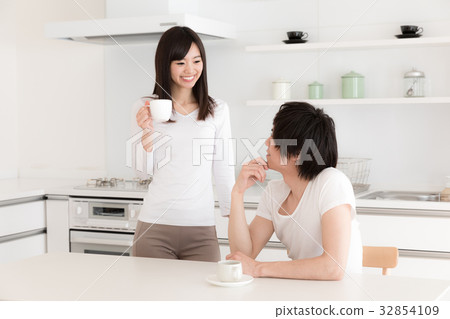 A couple relaxing in the kitchen A couple relaxing in the kitchen 32854109