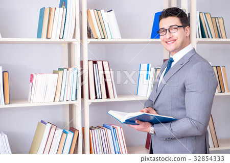 Businessman student reading a book studying in Businessman student reading a book studying in 32854333