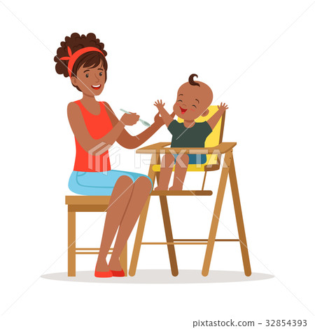 Happy young african mother feeding her baby in Happy young african mother feeding her baby in 32854393