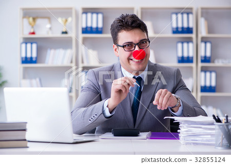 Clown businessman burning paper papers in the 32855124