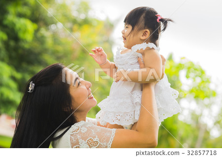Beautiful asian mom and baby playing happiness in the park , out 32857718