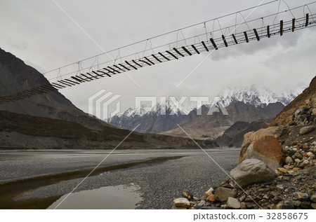 Pas-u Village suspension bridge and beautiful mountains in Pakistan 32858675