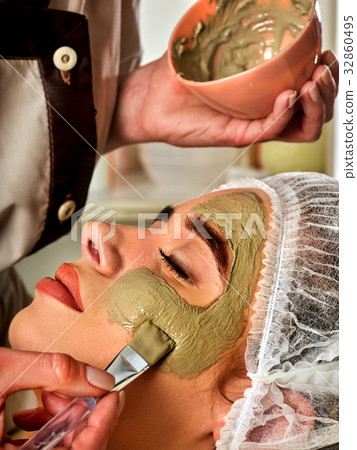 Mud facial mask of woman in spa salon. Face 32860495