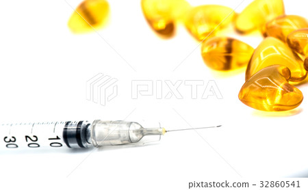 hypodermic syringe and pill, isolated on white  32860541