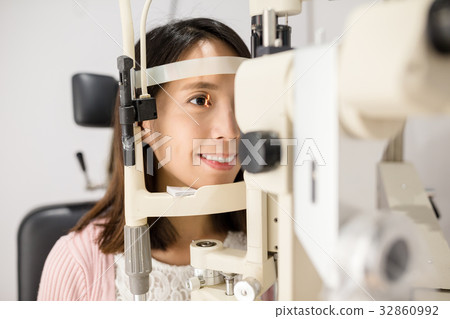 Woman is having eye exam 32860992