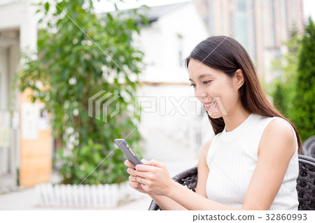 Woman texting message on cellphone 32860993