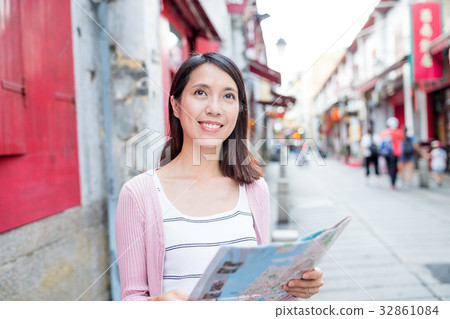 Woman looking at city map in Macao city Woman looking at city map in Macao city 32861084