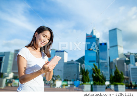 Woman using sms on mobile phone in Hong Kong Woman using sms on mobile phone in Hong Kong 32861132