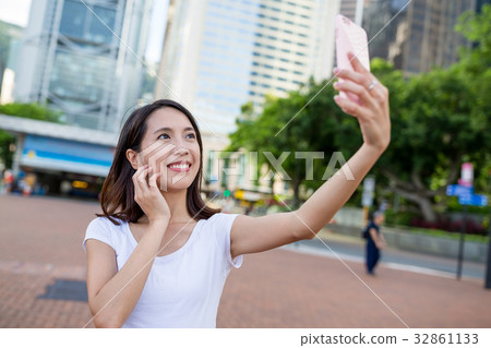 Woman taking selfie by mobile phone Woman taking selfie by mobile phone 32861133