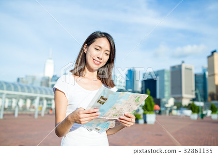 Woman checking on city map Woman checking on city map 32861135