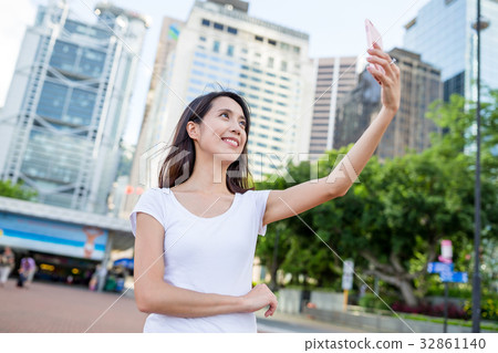 Young woman taking photo in Hong Kong city 32861140