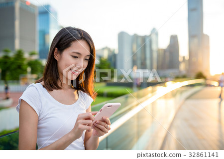 Woman sending sms on cellphone Woman sending sms on cellphone 32861141