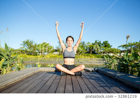 Woman doing yoga pose in park 32861219