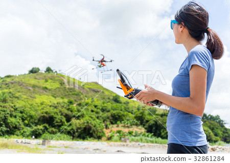 Young woman drives drone Young woman drives drone 32861284