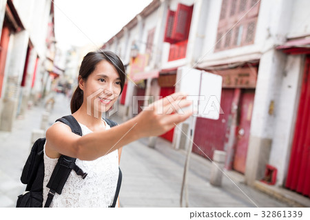 Woman taking selfie by digital camera 32861339