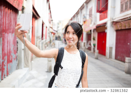 Woman taking selfie by digital camera 32861382