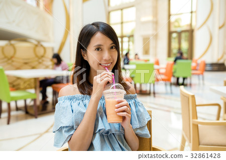 Woman drinking fruit juice Woman drinking fruit juice 32861428