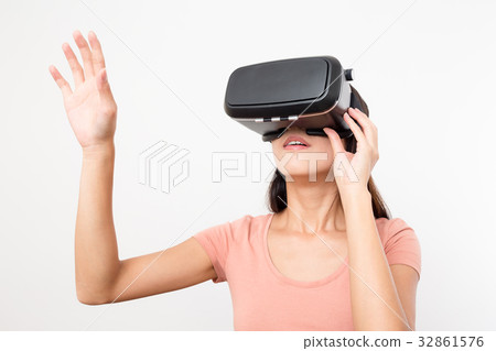 Woman looking though the VR device and hand up Woman looking though the VR device and hand up 32861576