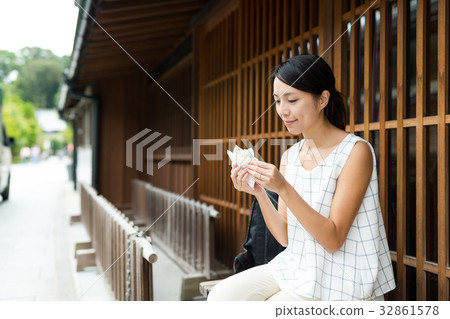 Woman enjoy snack in Japanese traditional house Woman enjoy snack in Japanese traditional house 32861578