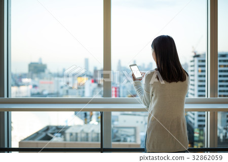 Woman use of cellphone inside office Woman use of cellphone inside office 32862059