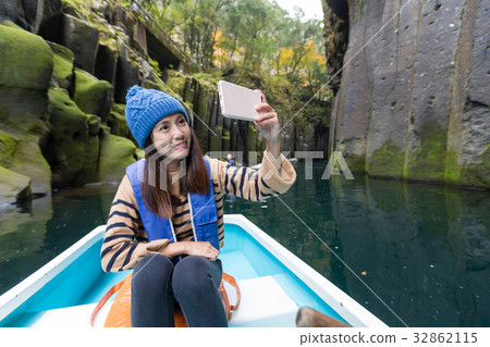 Woman taking photo and sitting on boat 32862115