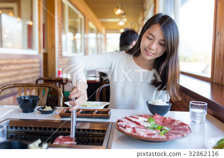 Woman enjoy roasted beef in japanese restaurant Woman enjoy roasted beef in japanese restaurant 32862116