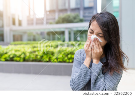 Asian Woman sneezing at outdoor 32862200