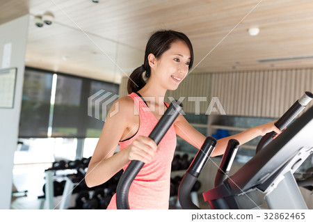 Sport Woman training on Elliptical machine in gym Sport Woman training on Elliptical machine in gym 32862465