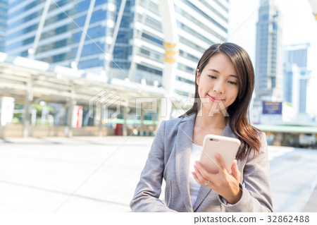 Businesswoman working on cellphone in bangkok city Businesswoman working on cellphone in bangkok city 32862488