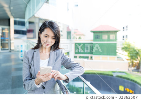 Businesswoman working on cellphone 32862507