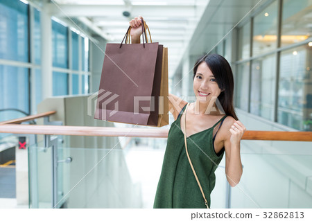 Excited woman holding shopping bag Excited woman holding shopping bag 32862813
