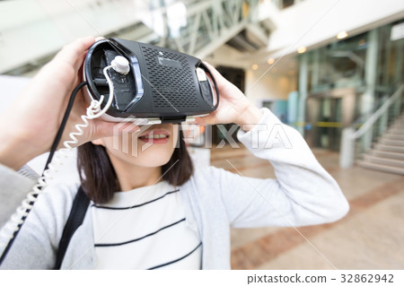 Woman looking with VR device Woman looking with VR device 32862942