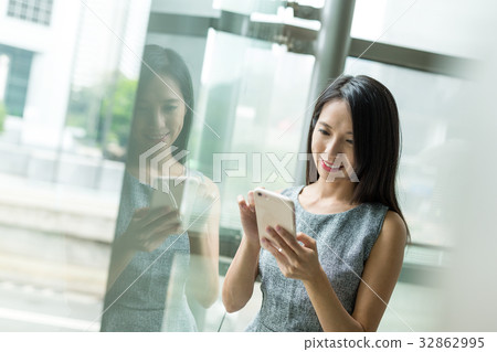 Businesswoman use of cellphone in office Businesswoman use of cellphone in office 32862995