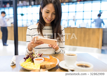 Woman taking photo on her dish Woman taking photo on her dish 32862999