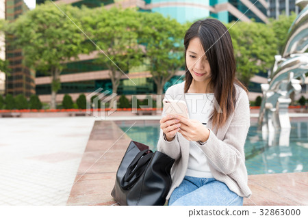 Young Woman using mobile phone at outdoor Young Woman using mobile phone at outdoor 32863000