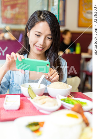 Woman taking phone on cellphone in chinese restaurant 32863037