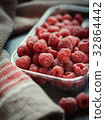 Fresh raspberries in a disposable plate 32864442