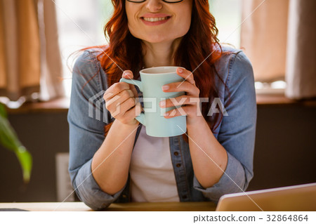 Woman working on freelance enjoying coffee break. 32864864