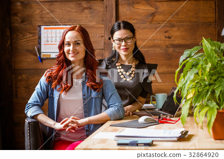 Brunette ladyboss and ginger freelancer woman at Brunette ladyboss and ginger freelancer woman at 32864920