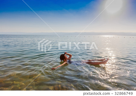 Girl floating on surface of Dead Sea, Jordan. Girl floating on surface of Dead Sea, Jordan. 32866749