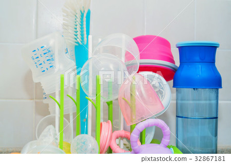 Washed baby bottles on plastic drying rack Washed baby bottles on plastic drying rack 32867181