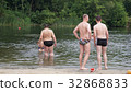 guys relax on the beach standing on the shore 32868833