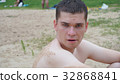 guys relax on the beach standing on the shore 32868841