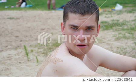 guys relax on the beach standing on the shore guys relax on the beach standing on the shore 32868841