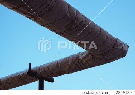 Insulated heating pipes outdoors against the sky Insulated heating pipes outdoors against the sky 32869120