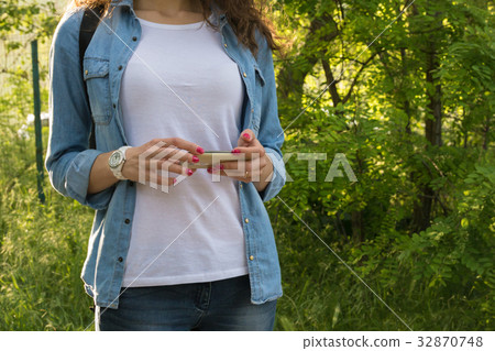 Young woman using a mobile phone Young woman using a mobile phone 32870748