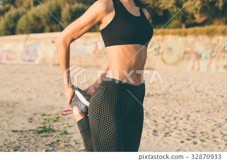 Woman in sportswear doing exercises Woman in sportswear doing exercises 32870933